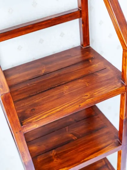 A close-up of the solid wood planks used for the shelves, showcasing the rich grain and finish.