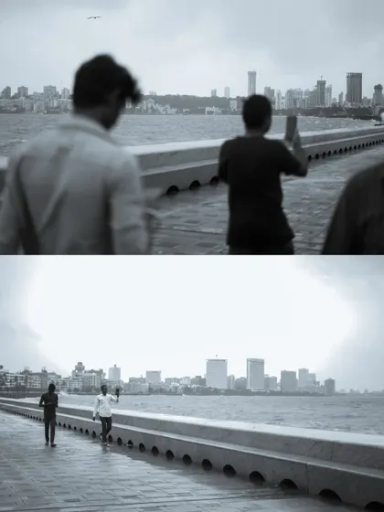 A black and white photo series capturing the spirit of Mumbai's monsoon at Marine Drive. People are seen enjoying the high tide, getting drenched by waves, and finding joy in the downpour.