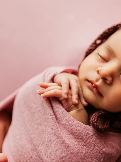 Another artistic close-up, this time showing the baby's profile and tiny hands.