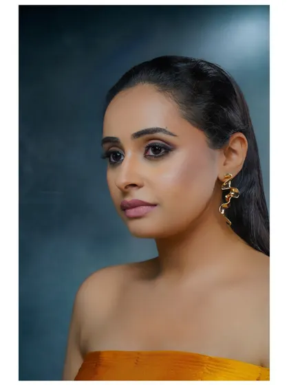 A profile shot from the same series, showing a different angle and highlighting the elegant earrings.