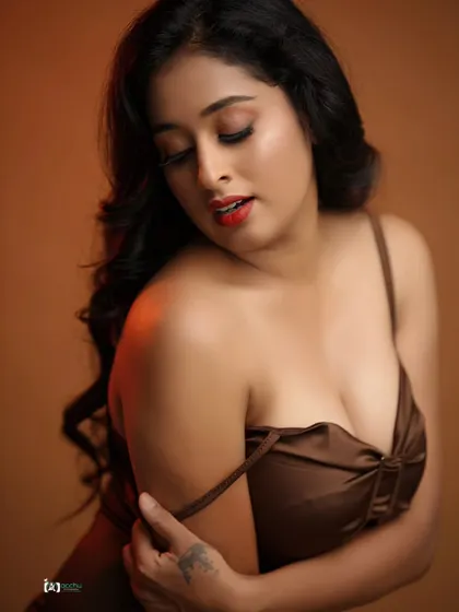 A close-up portrait that's all about warmth and intimacy. The soft lighting and rich brown tones create a sensual and inviting mood, perfect for a bold and beautiful photoshoot.