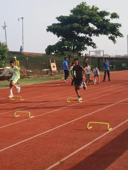 A group of athletes participates in a jump training workshop on the track. These specialized sessions focus on improving technique for events like long jump and high jump through targeted drills.
