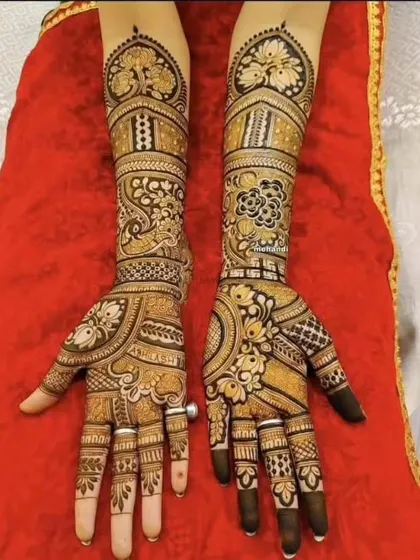This full-hand design is perfect for an engagement or wedding. It features peacocks and floral patterns with shaded details, and the fingertips are left open before being filled for a sharp look.