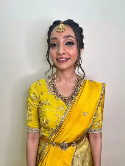 A smiling portrait that captures the essence of this simple yet elegant look. The makeup is fresh and light, perfect for a daytime wedding ceremony.