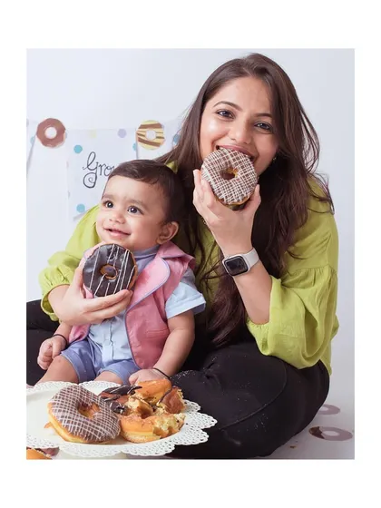 A fun donut-themed milestone shoot with a mother and her baby.