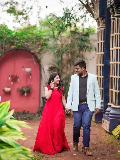A romantic stroll through a colorful courtyard, with the couple holding hands.
