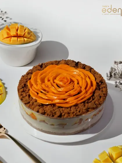 Artistry you can eat. Our Mango Rose Cake is a showstopper, featuring thinly sliced mangoes arranged in a floral pattern over a bed of crumble.