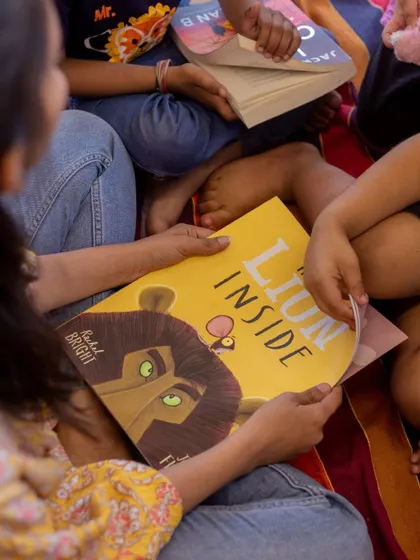 A teacher reads "The Lion Inside" to a group of captivated children. We use powerful stories like this to teach important life lessons about courage and self-belief.