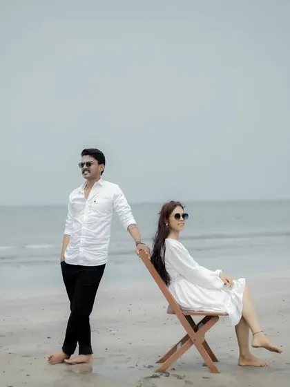 A stylish, relaxed portrait on the sand. This kind of shot has a cool, editorial feel, perfect for modern couple photography.