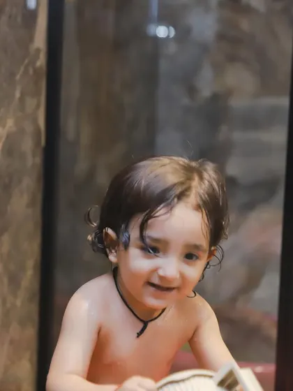 A sweet, smiling baby enjoying the water. These sessions are perfect for capturing your little one's playful side.