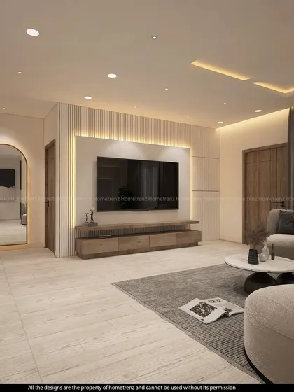 A bright and airy living room with a simple, elegant TV unit. The arched, back-lit mirror is a beautiful feature that adds depth and a touch of glamour to the space.