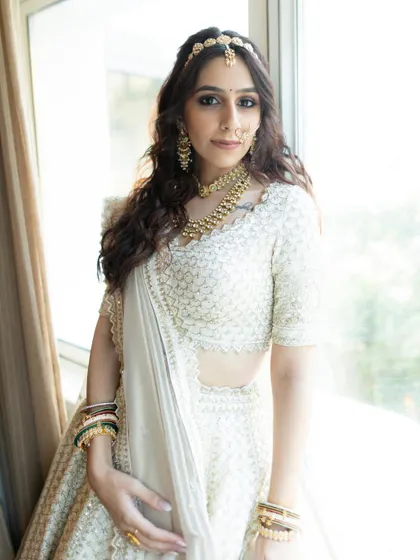 Another beautiful portrait of the bride in her white lehenga, looking directly at the camera. Her confidence and grace shine through in this image.