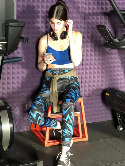 Taking a moment to check her phone between exercises. Our studio is a place where your fitness journey fits into your life.