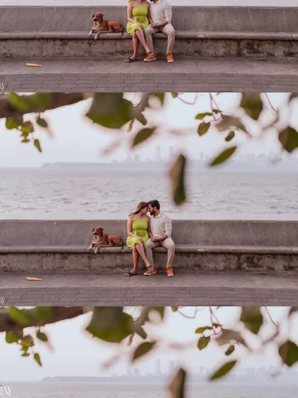 A wide shot capturing the couple and their dog enjoying the view at Marine Drive, showing the full scene.