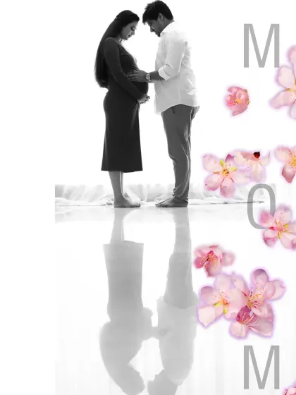 A creative and artistic edit combining a black and white silhouette with delicate pink flowers. This portrait beautifully symbolizes the new life and love that is blossoming.