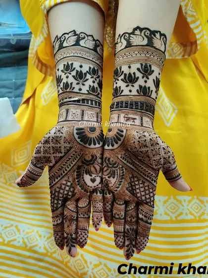 A beautiful custom design for a sister, featuring her favorite motifs: swans and lotuses. The bold, dark henna makes the design truly stand out.