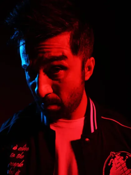 A close up portrait with the red and blue lighting. It brings out a different kind of intensity.
