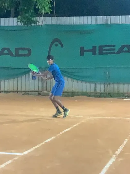 A player hitting a solid backhand during an evening practice. The court is always ready for you.
