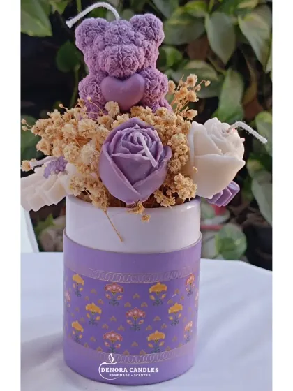The purple flower bouquet candle, showing my brand logo on the box.