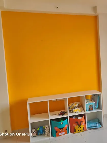 Sometimes, a single, bright accent wall is all you need. We painted this wall in a vibrant yellow to create a happy and energetic space for a child's play area.