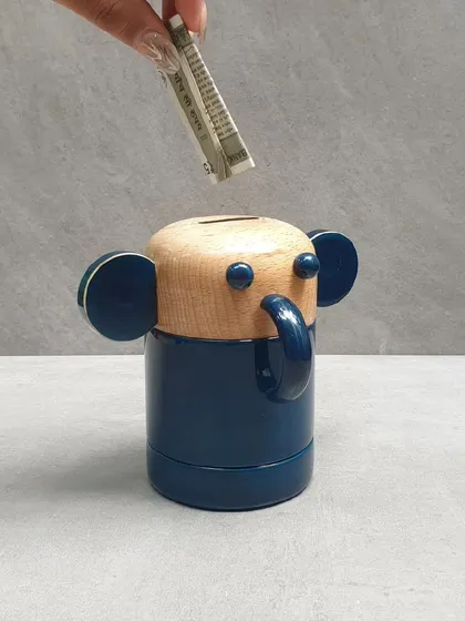 Our elephant money bank is another charming way to encourage saving. Made from sustainable wood and finished with natural dyes, it's a delightful and useful addition to any desk.