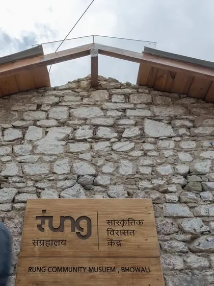 A low-angle view of the museum's signage and the gabled roof with its new skylight, symbolizing the blend of preservation and modern intervention.