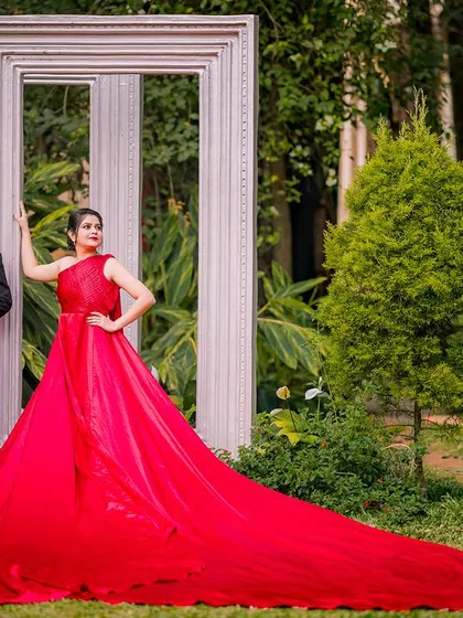 A stylish pose using the large white frames as a backdrop. The long train of the red gown spreads out, creating a stunning carpet of color in this fashion-forward portrait.