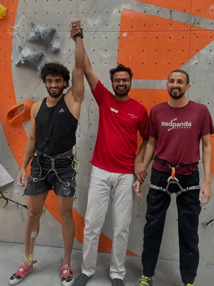 Celebrating the winners of the Men's Speed Climbing competition. Our crew member raises the champion's hand in victory.
