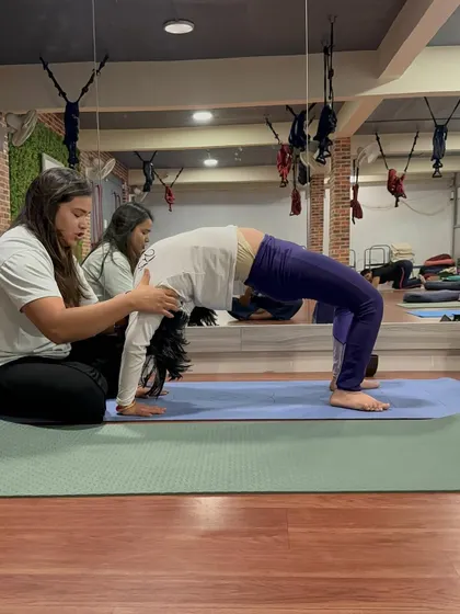 On Guru Purnima, I received this beautiful gift from a student. Here I am assisting her in Urdhva Dhanurasana (Wheel Pose), ensuring her shoulders are properly aligned for a safe backbend.