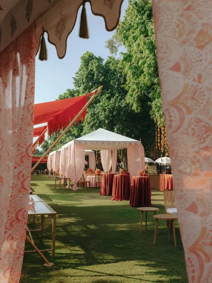 A peek into the vibrant outdoor festivities for Sid and Kanika's wedding at Rambagh Palace. The colorful tents create a celebratory atmosphere.