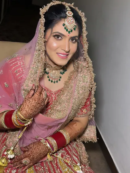 A portrait of my pretty bride Pooja for her Anand Karaj. The makeup is fresh and luminous, with a pop of pink on the lips to match her beautiful lehenga.