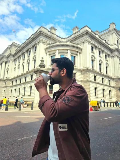 A candid-style photo of me enjoying a coffee on a London street. This natural, in-the-moment shot is effective for lifestyle brands that want to convey an authentic, everyday feel.