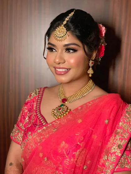 A complete traditional bridal look. Simran looks absolutely radiant, with makeup that enhances her features without overpowering her natural beauty.
