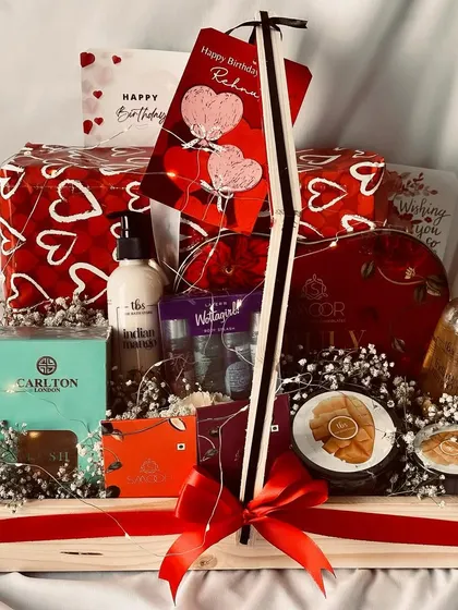 The full view of the "Happy Birthday Rehana" hamper, elegantly arranged in a pinewood basket with a red ribbon.