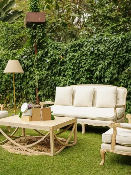 A vintage-inspired lounge area set up on the lawn, providing a comfortable and elegant seating option for guests.