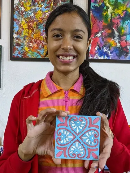 A participant with her beautiful Moroccan-tile-inspired painting, which shares the geometric and meditative qualities of mandala art.