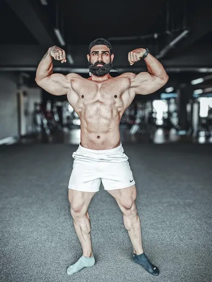 A powerful front double bicep pose, showcasing symmetry and conditioning. This is the result of countless hours of training and dieting, presented with confidence.
