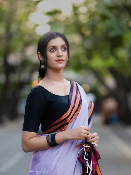 A portrait that highlights the model's serene expression, perfectly matching the timeless vibe of the Ilkal saree.