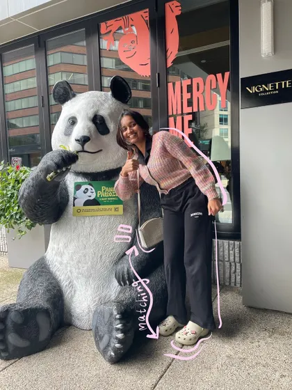 Posing with a panda statue. The pink doodles highlight the matching elements in our "outfits."