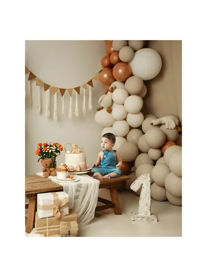 A quiet moment during a first birthday shoot. This little one sits patiently by his cake and presents, creating a calm and beautiful portrait amidst the celebration.