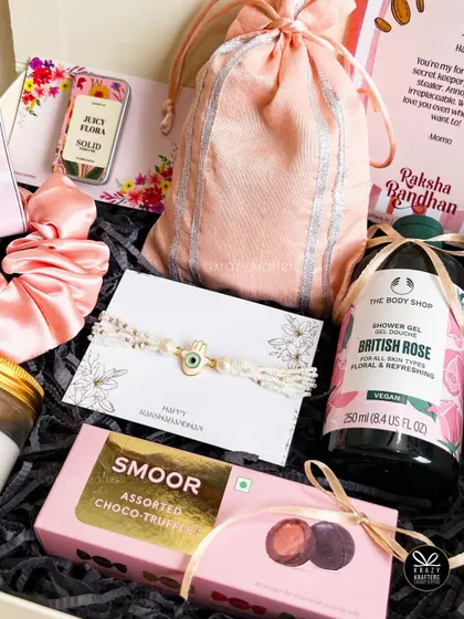 A top-down view of the 'Bandhu' sister hamper, showing the lovely arrangement of all the pink-themed goodies.