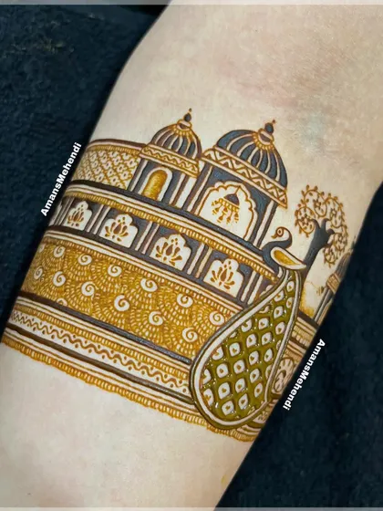 The design taking shape with shading and filling. The peacock's feathers and the palace architecture begin to come alive with depth and detail.