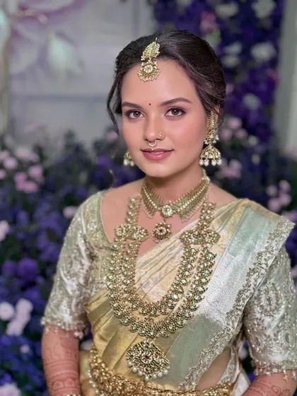 Sushmitha's radiant smile, a testament to her feeling comfortable and beautiful on her special day.