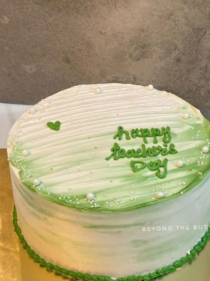A simple and elegant Teacher's Day cake with a green watercolor effect.