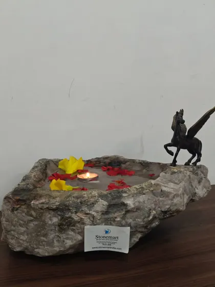 Another angle of the natural stone uruli, shown here with a decorative Pegasus statue to highlight its use as a display piece.