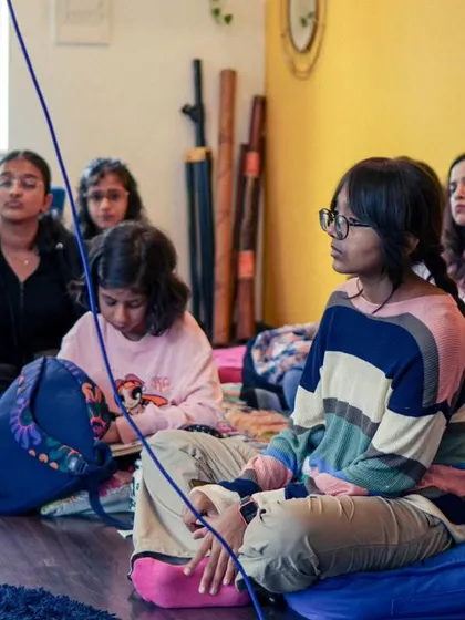 A group of students participating in a vocal workshop, soaking in the knowledge.