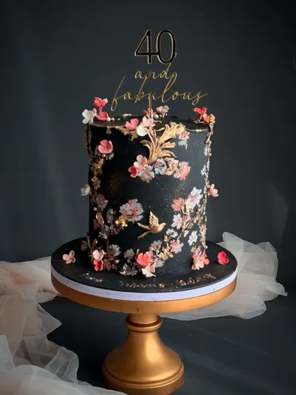 A breathtaking black cake with hand painted cherry blossoms and gold accents. This design is a true work of art, perfect for a milestone "40 and fabulous" celebration.