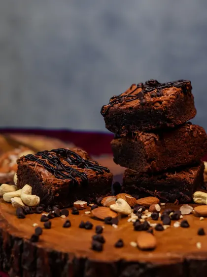 A stacked tower of our nutty brownies. This shot highlights the rich texture and the generous amount of nuts and chocolate chips baked into every piece.