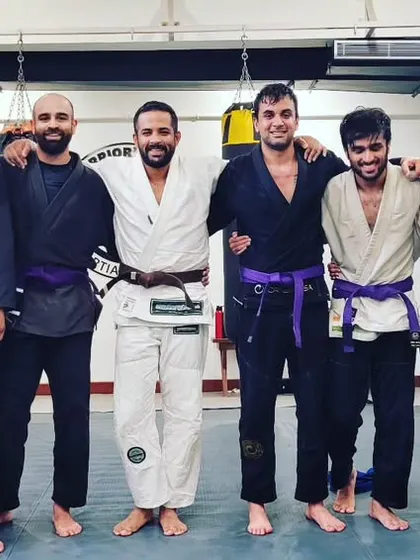 Another shot of our newly promoted purple belts with the coaching staff.