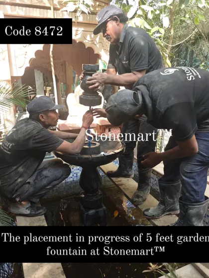 The placement of the 5-foot garden fountain requires precision and teamwork. Here, my crew carefully assembles the multi-part Grandessa fountain.